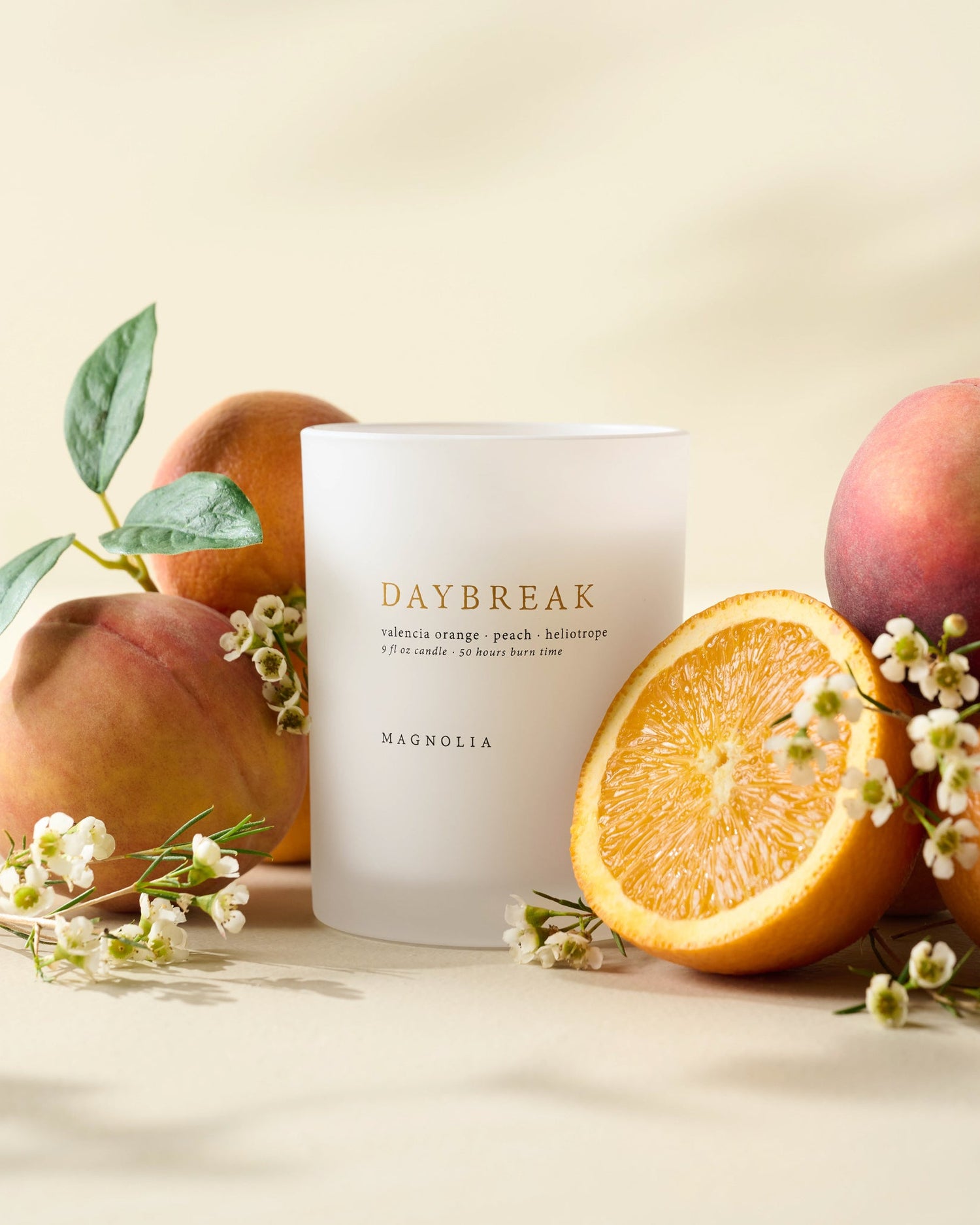 Magnolia Daybreak Candle with peaches, oranges and flowers