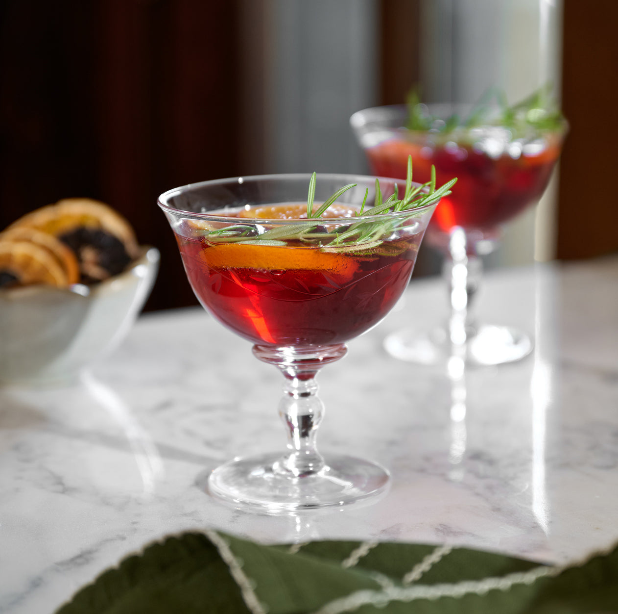 Cocktail with garnish in a glass on a marble surface