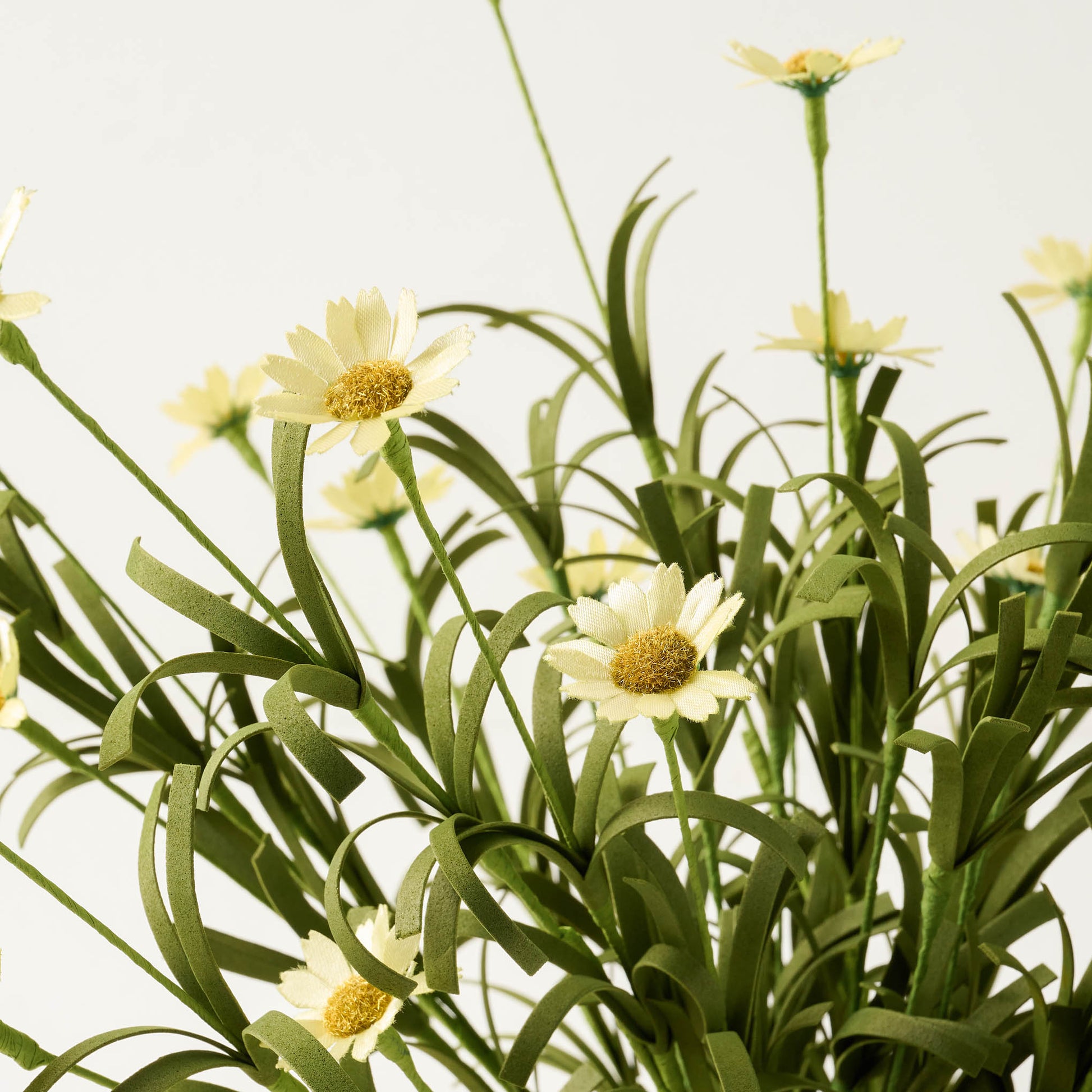 close up view of faux yellow daisy florals in bouquet
