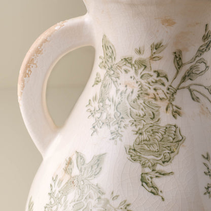 Close up of distressed vase Green and White floral detail