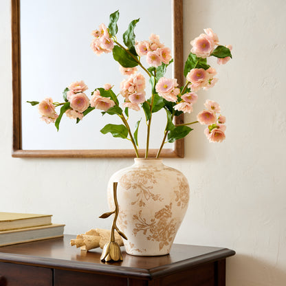 Floral Antique Brass Bell paired with distressed ceramic vase and florals on top of console table