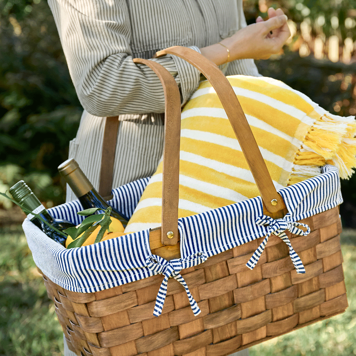 GIF of a picnic basket, dinnerware and a picnic spread with salad and dishes.