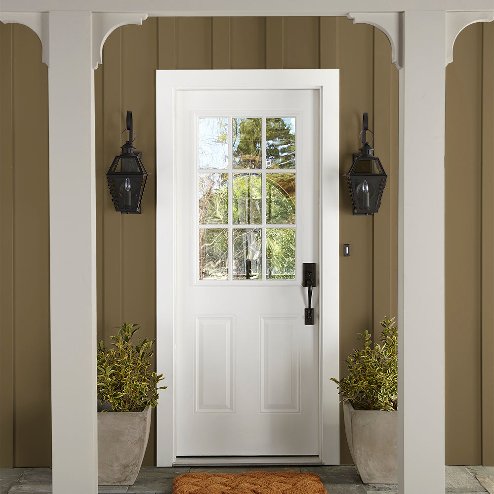 rich green with brown undertone paint color named remote trail shown painted on exterior siding
