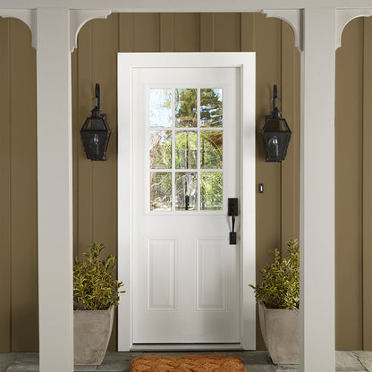 rich green with brown undertone paint color named remote trail shown painted on exterior siding