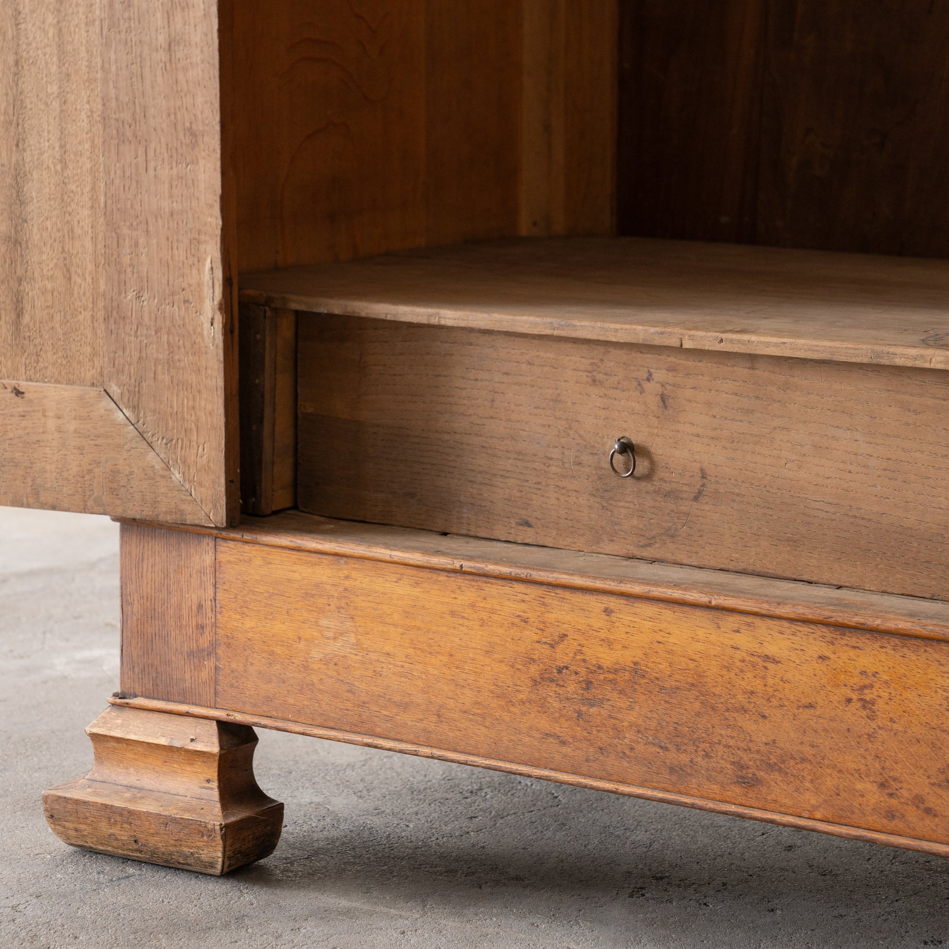 detail view of bottom drawer inside antique wood armoire