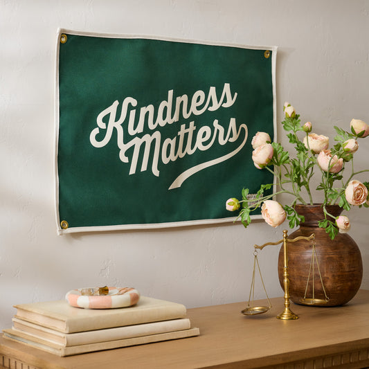 "Kindness Matters" Canvas Flag shown hung above dresser