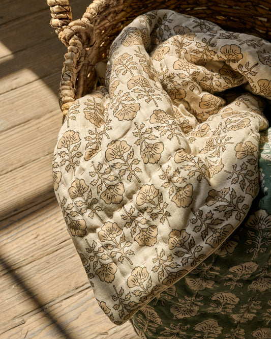 Flora Block Print Quilt - Natural laying inside basket