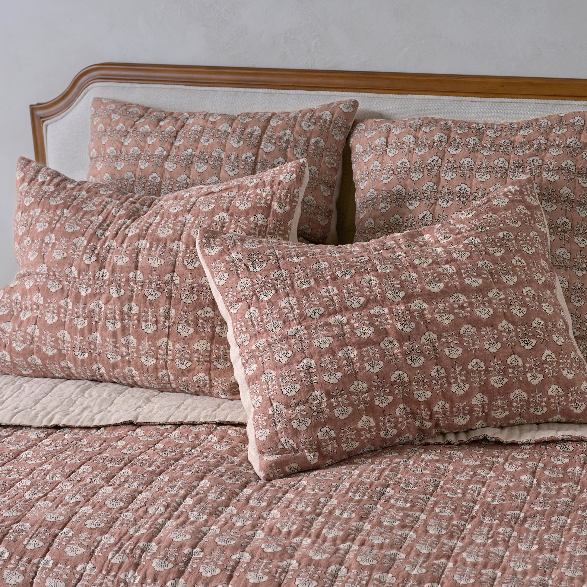 Flora Block Print Pillow Sham - Desert Clay shown on bed