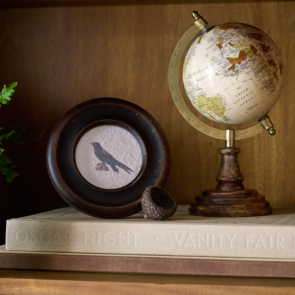 Vintage Framed Bird Print shown standing up with other decor