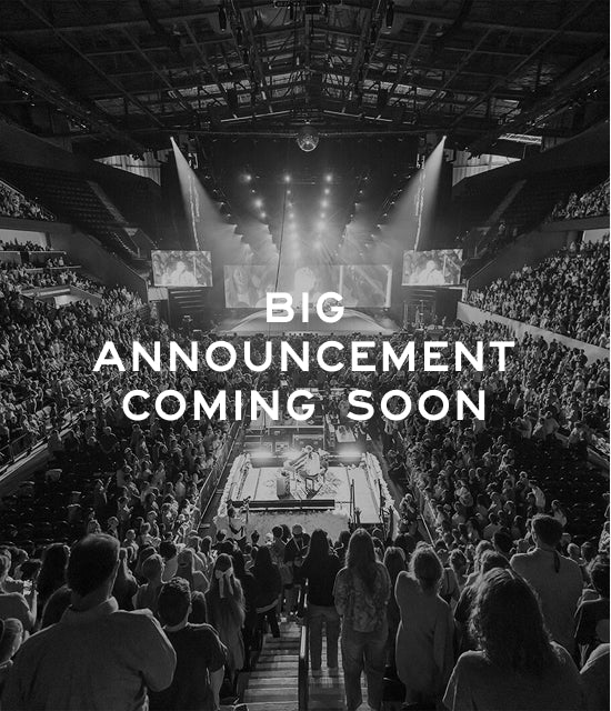 Large indoor arena with spectators and text 'BIG ANNOUNCEMENT COMING SOON' displayed.