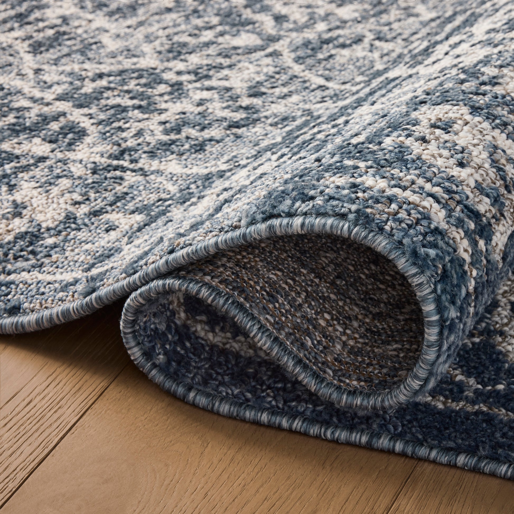 Gigi Navy Stone Rug close up of rolled rug