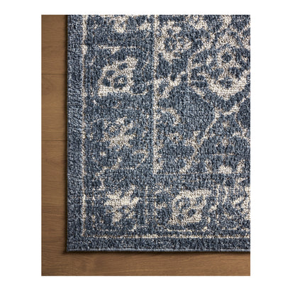 Gigi Navy Stone Rug close up of corner on wood floor