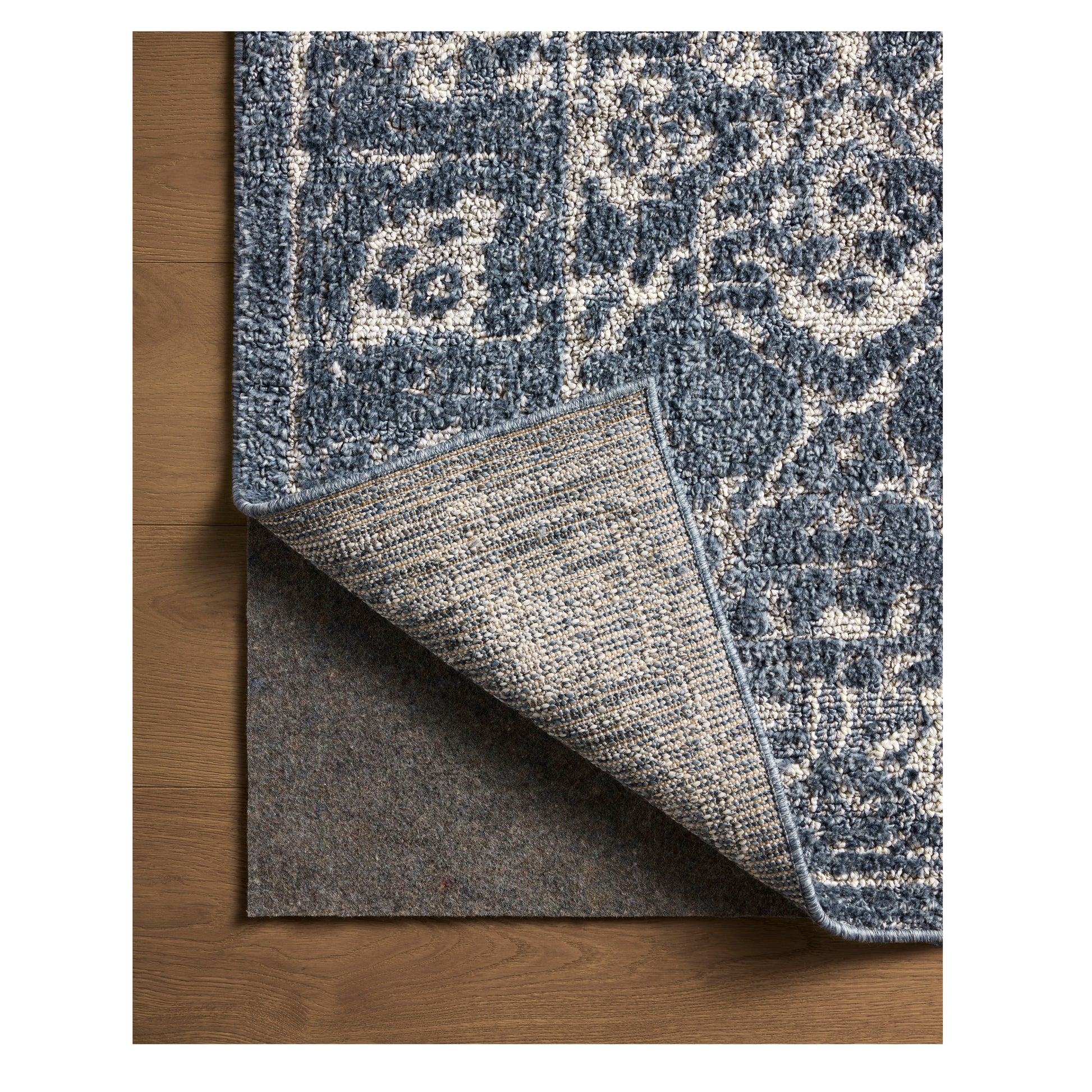 Gigi Navy Stone Rug close up of corner flipped back