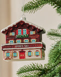 Ski Lodge Ornament shown hung from tree