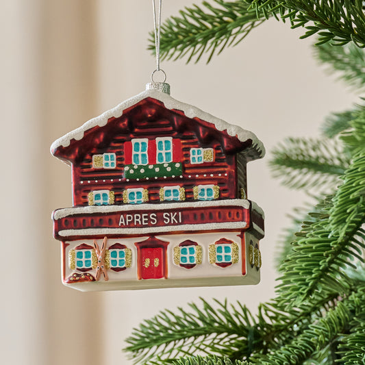 Ski Lodge Ornament shown hung from tree