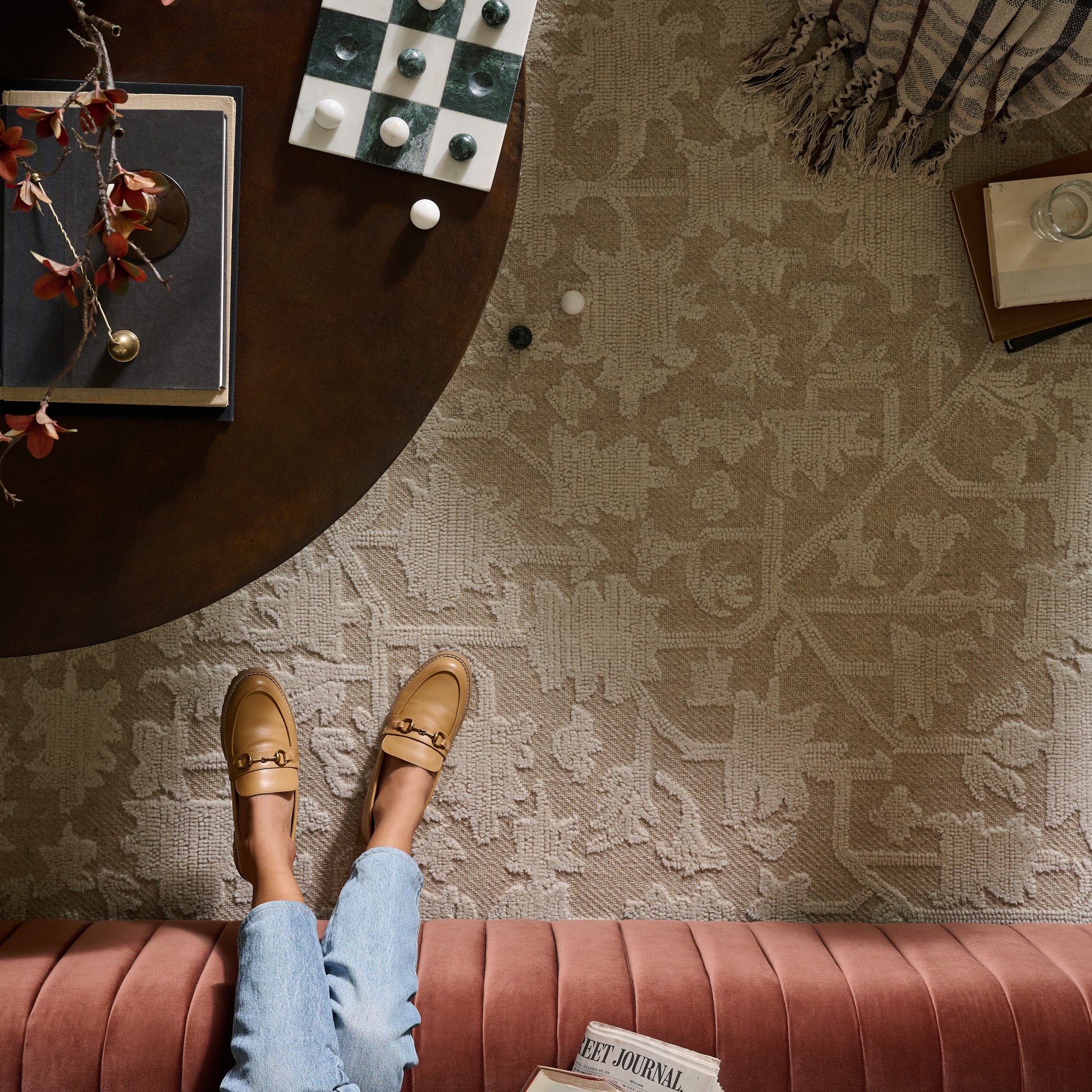 Gloria Natural Ivory Rug top view looking down on rug, coffee table and sofa
