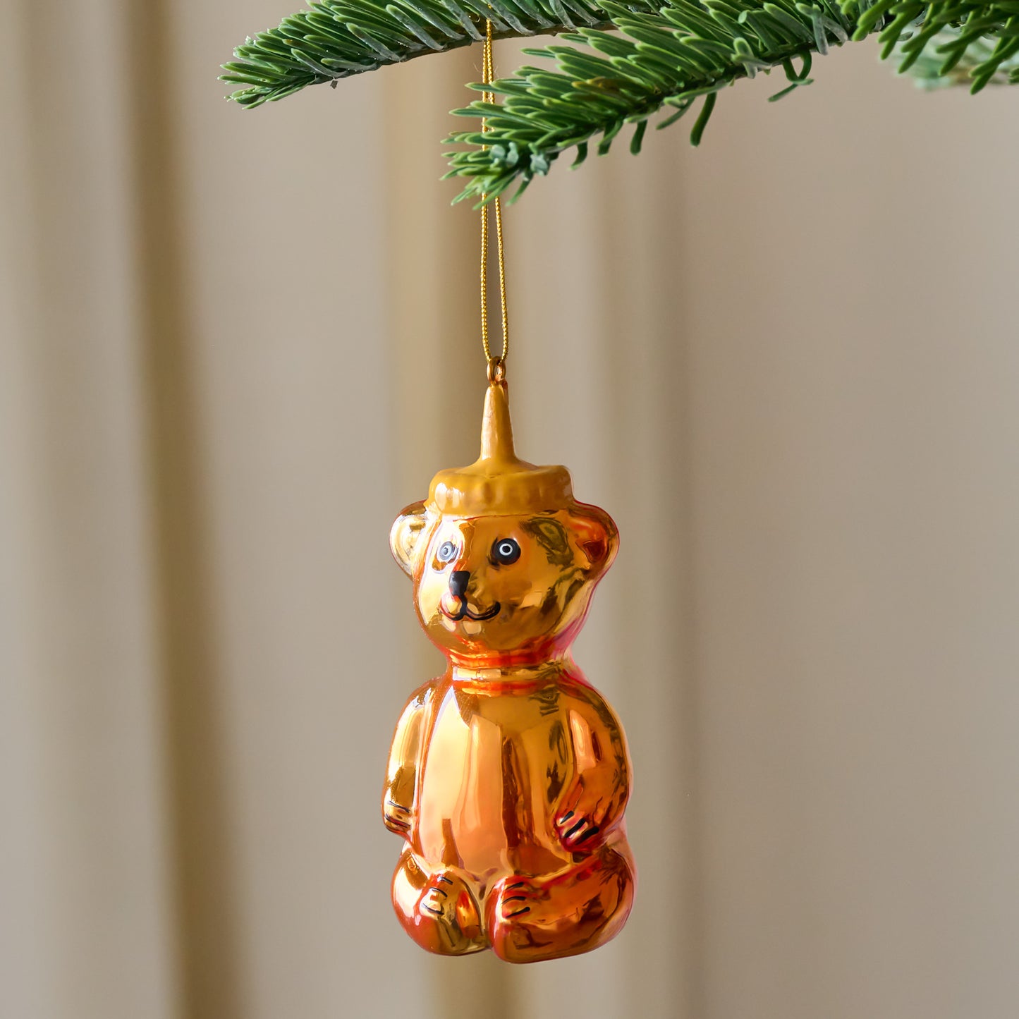 Honey Bear Ornament shown hung from tree