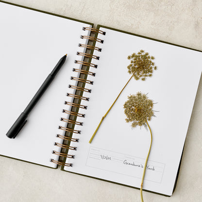 Herbarium Journal open to a page with dried flowers
