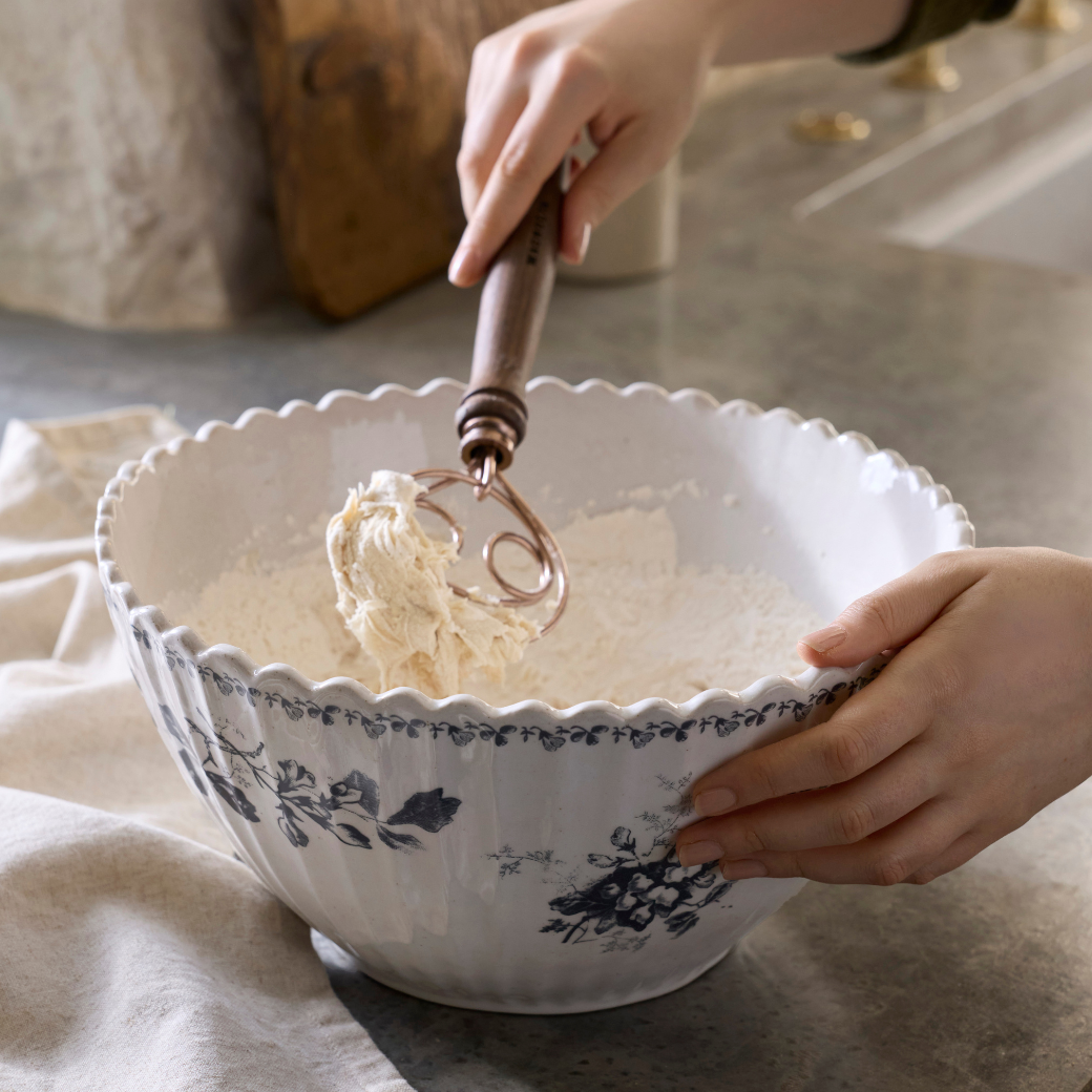 Heirloom Floral Large Mix + Serve Bowl mixing dough with whisk in hand