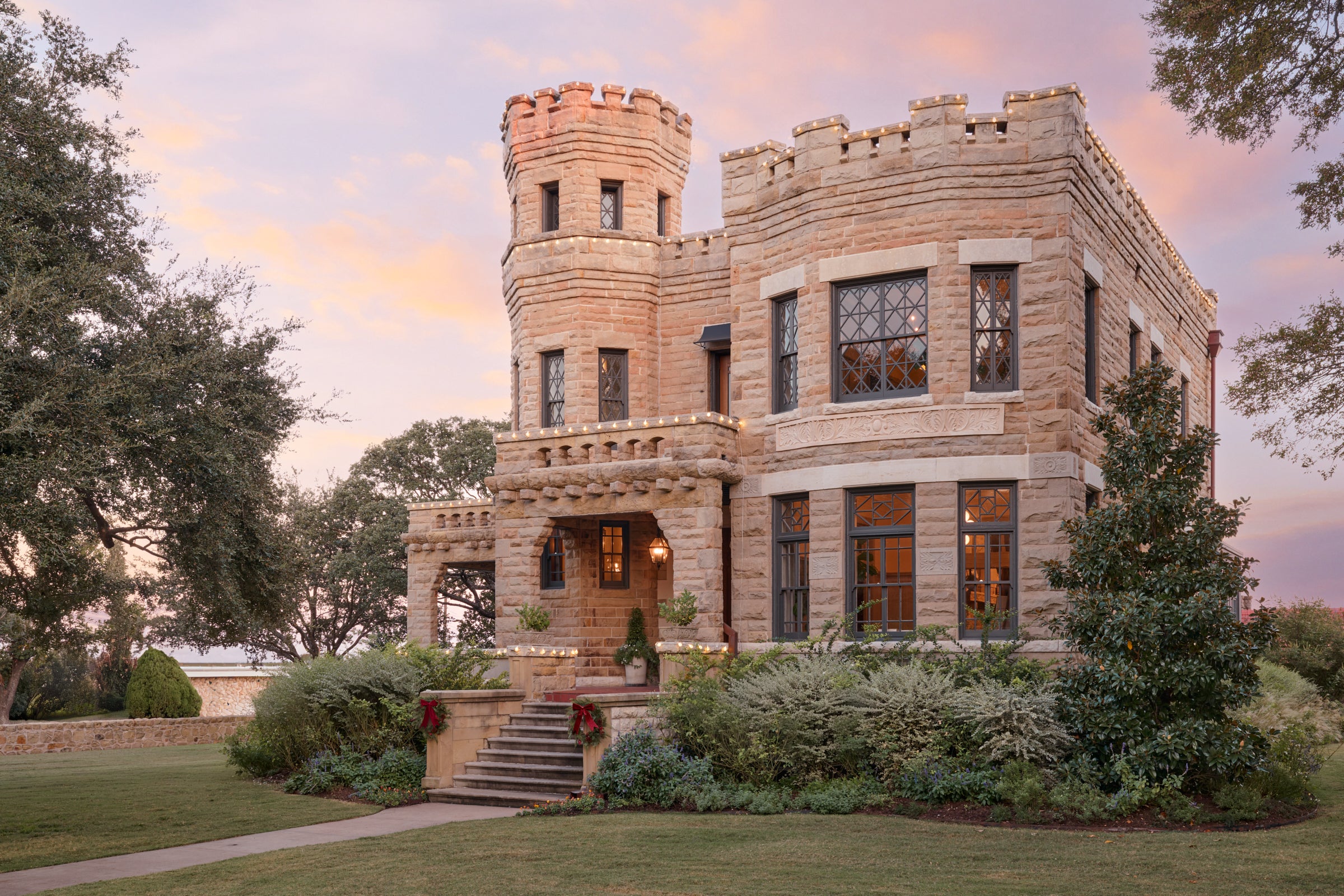 The Castle decorated in holiday lights and holiday wreaths.