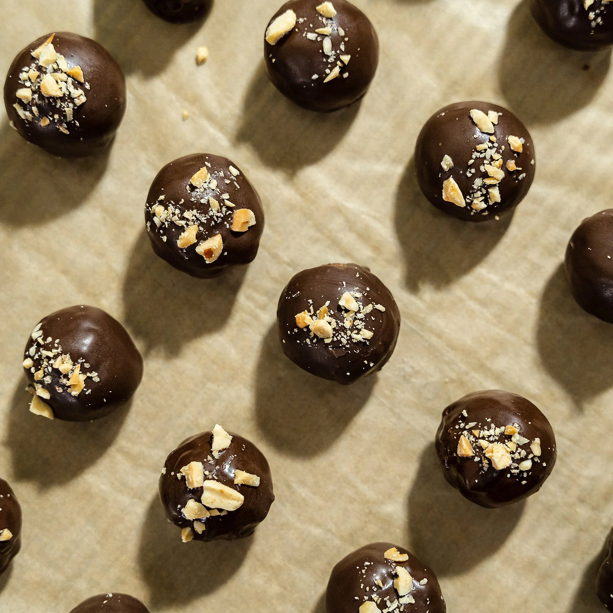 Peanut Butter Balls with nuts on a baking sheet.