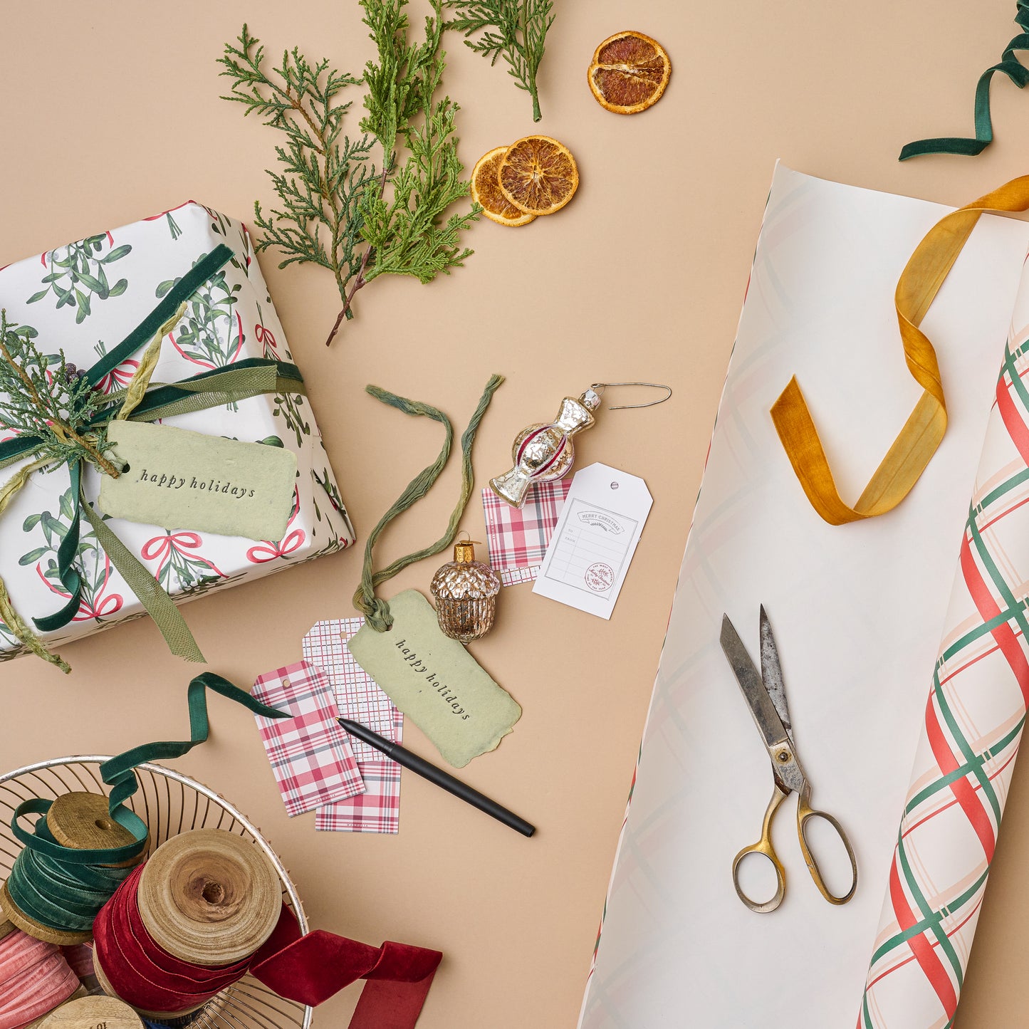 Vintage Holiday Plaid Wrapping Paper Sheets tube with scissors next to wrapping embellishments
