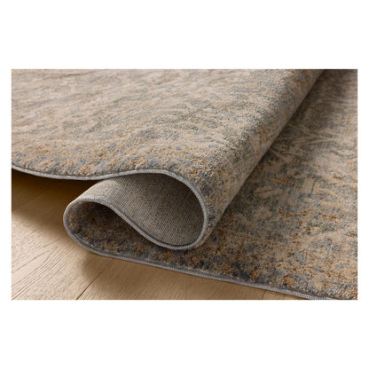 Junie Blue Natural Rug shown rolled over itself