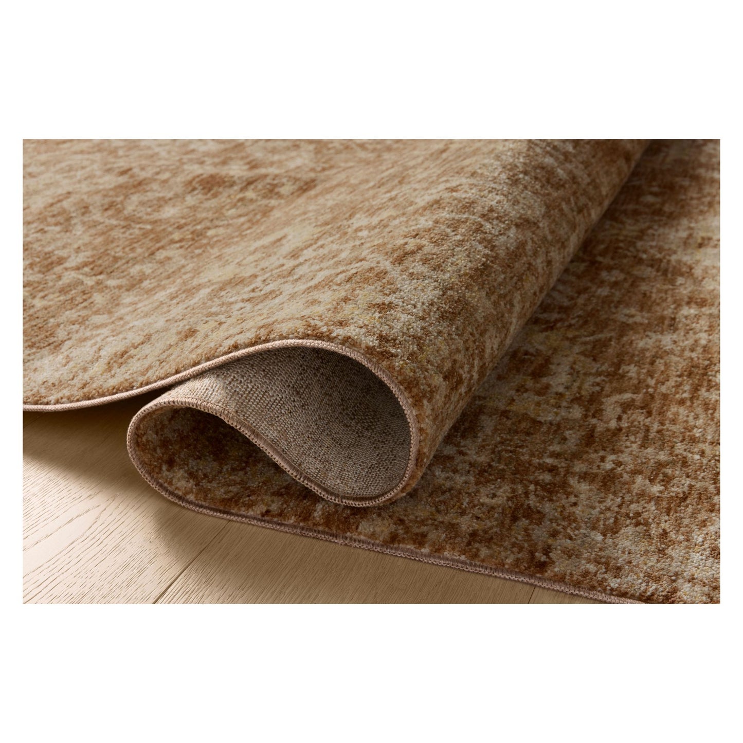 Junie Clay Natural Rug shown rolled over itself