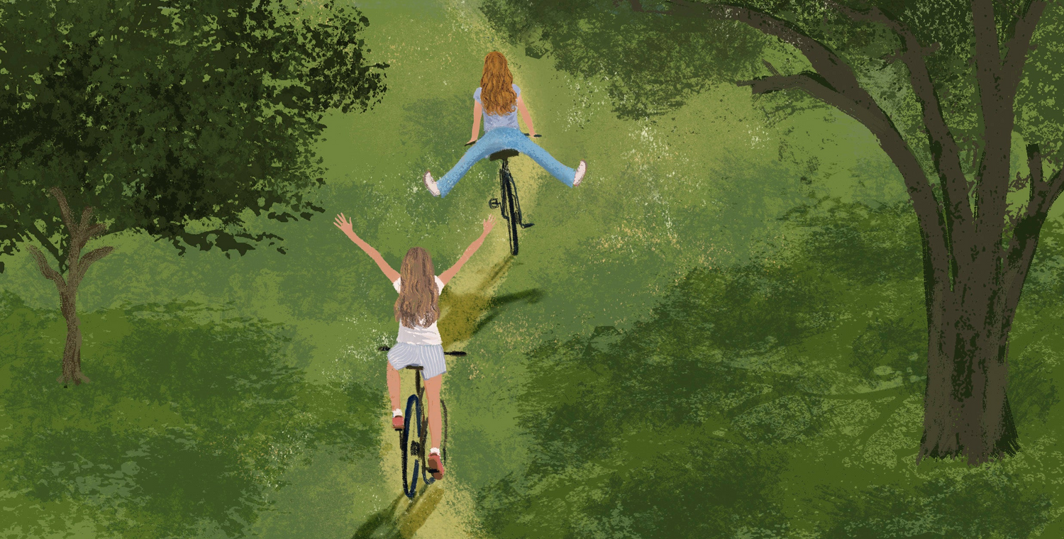 Two people riding bicycles in a park with trees and a rainbow in the background