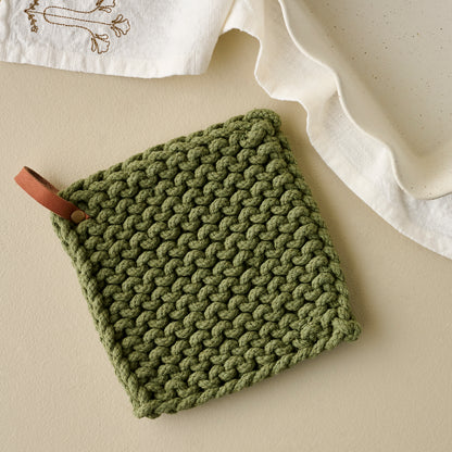 Hand Crocheted Cotton Pot Holder in Green shown with tea towel