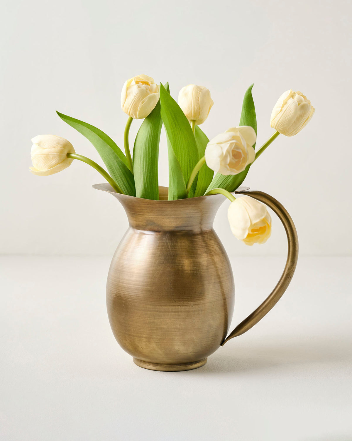 Ruthie Brass Pitcher Vase shown with florals