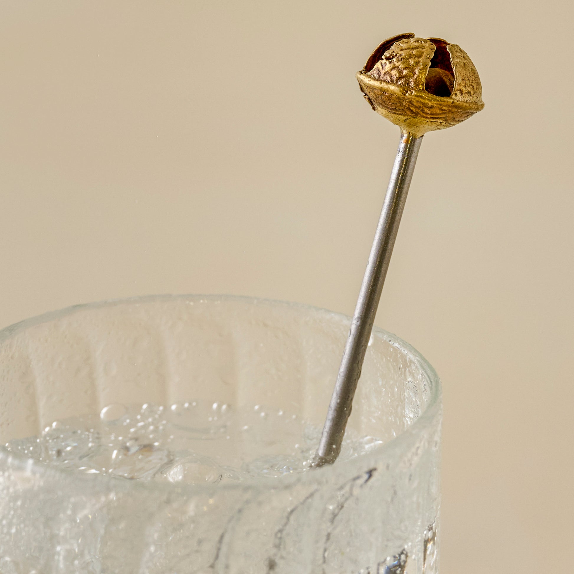 Brass Jingle Bell Cocktail Stirrers up close