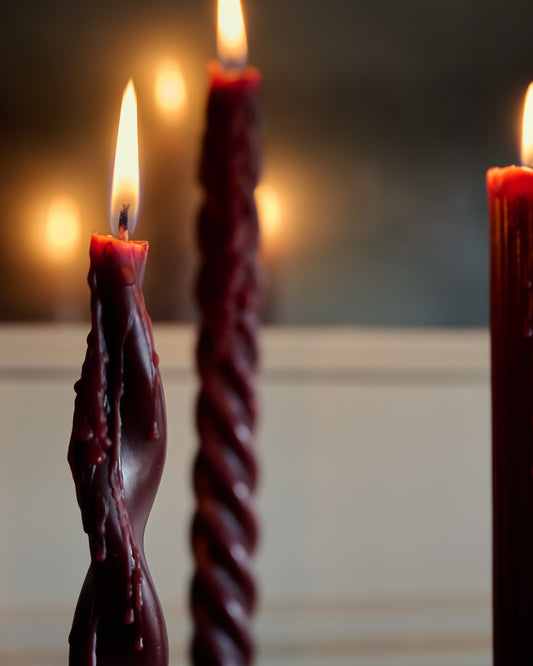 Assorted Drippy Taper Candle - Burgundy close up lit