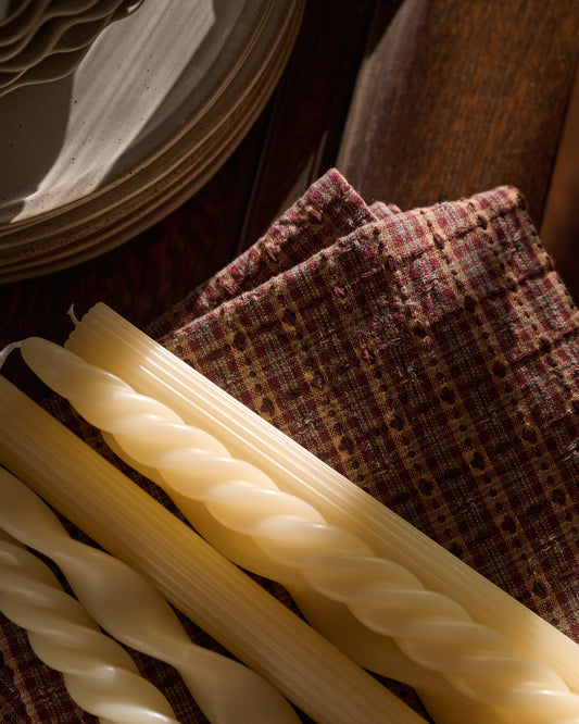 Assorted Drippy Taper Candle - Cream on top of linens