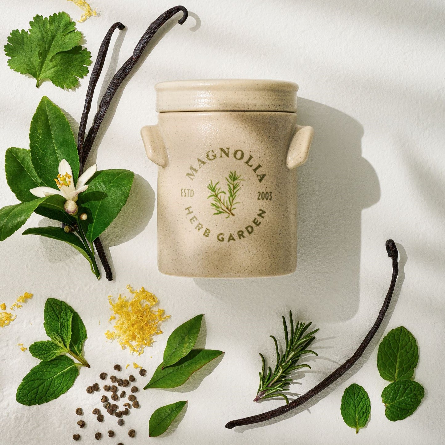 herb garden candle shows scent notes including mandarin leaf and rosemary