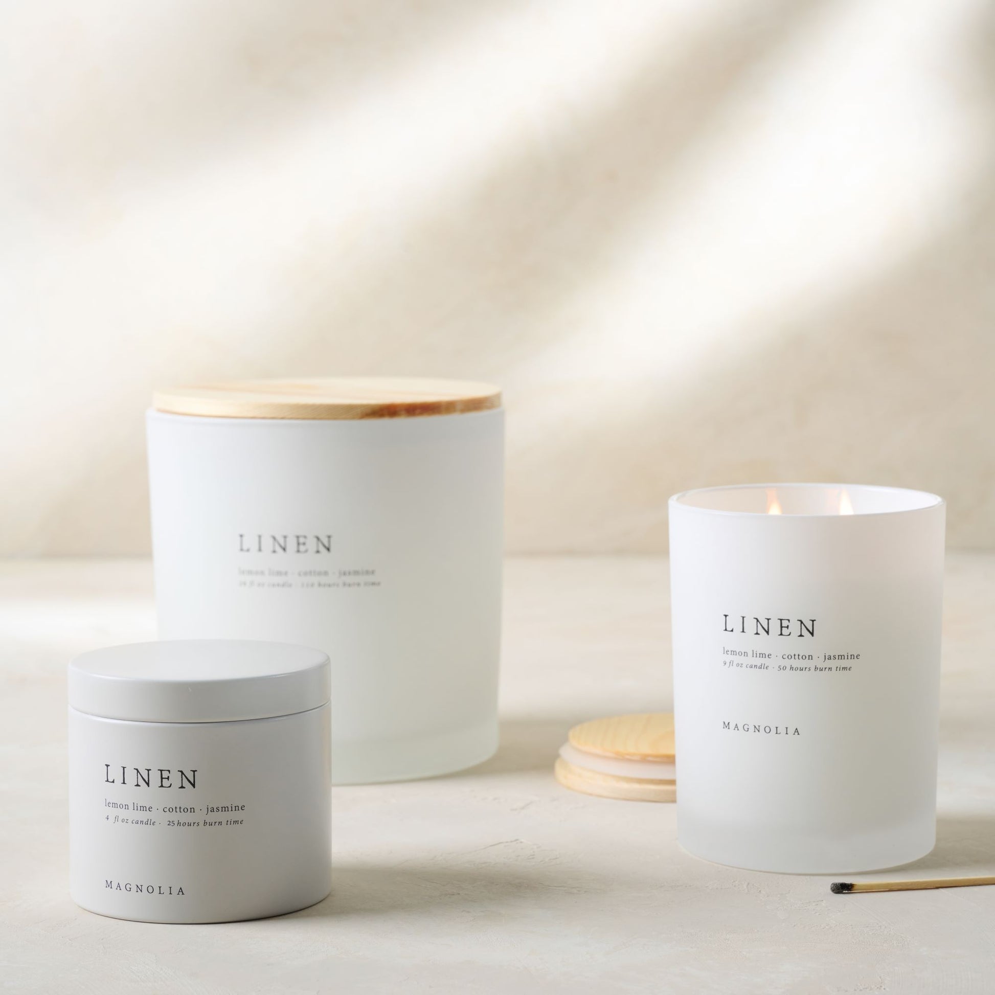 magnolia linen candles of various sizes grouped 