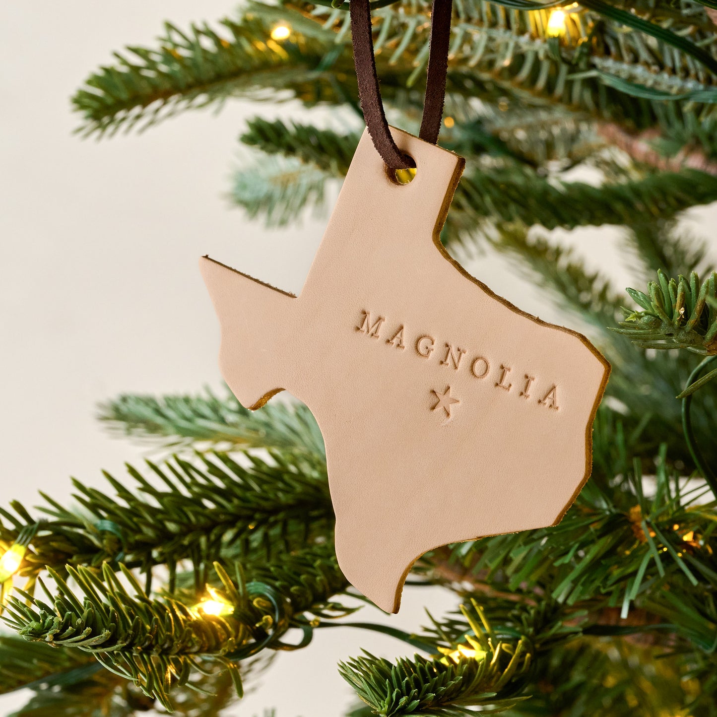 Texas Magnolia Leather Ornament shown on tree