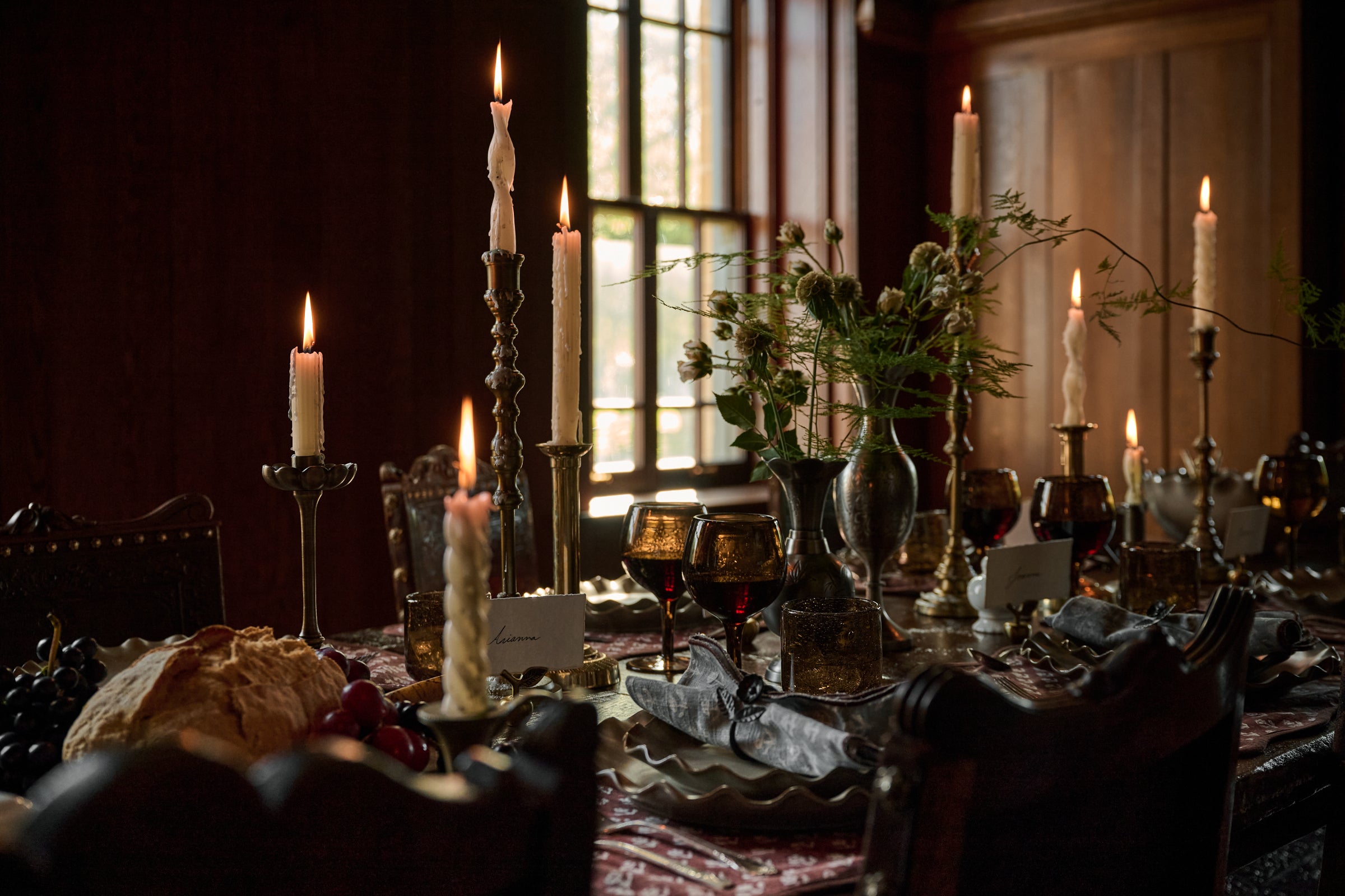 Elegant dining table setting with plates, glasses, and decorative elements.