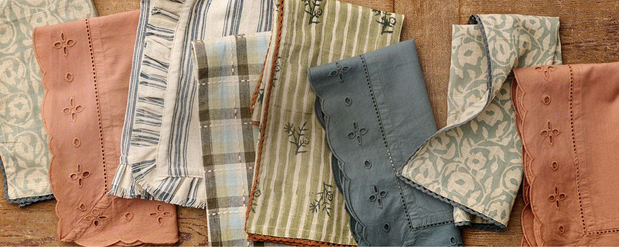 Collection of patterned fabric samples on a wooden surface