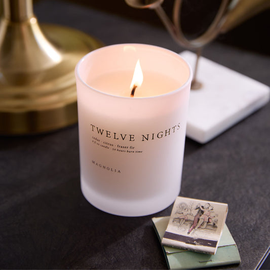 Magnolia Twelve Nights Candle shown burning