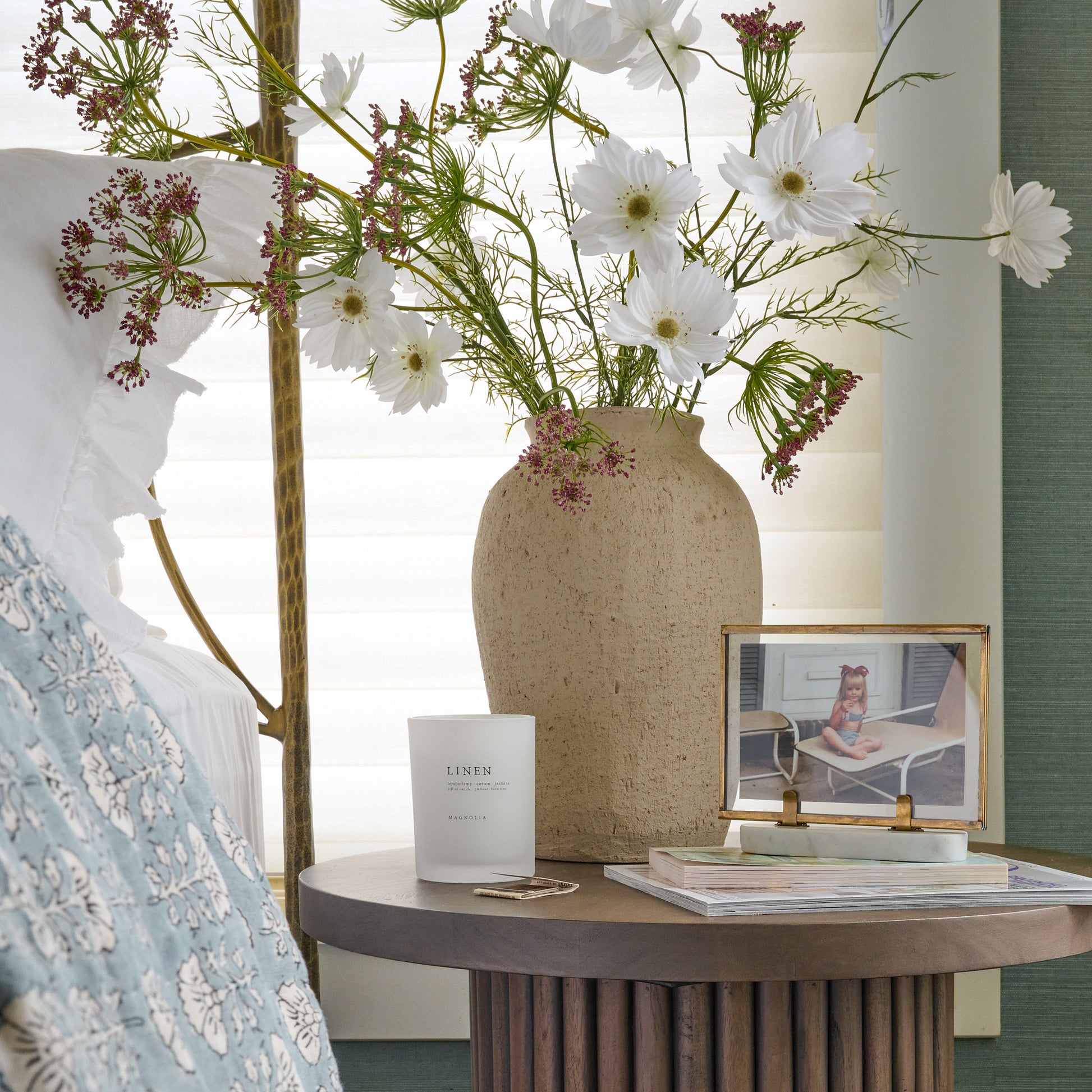 Small Textured Adrienne Vase on a bedside table next to a candle and framed photo