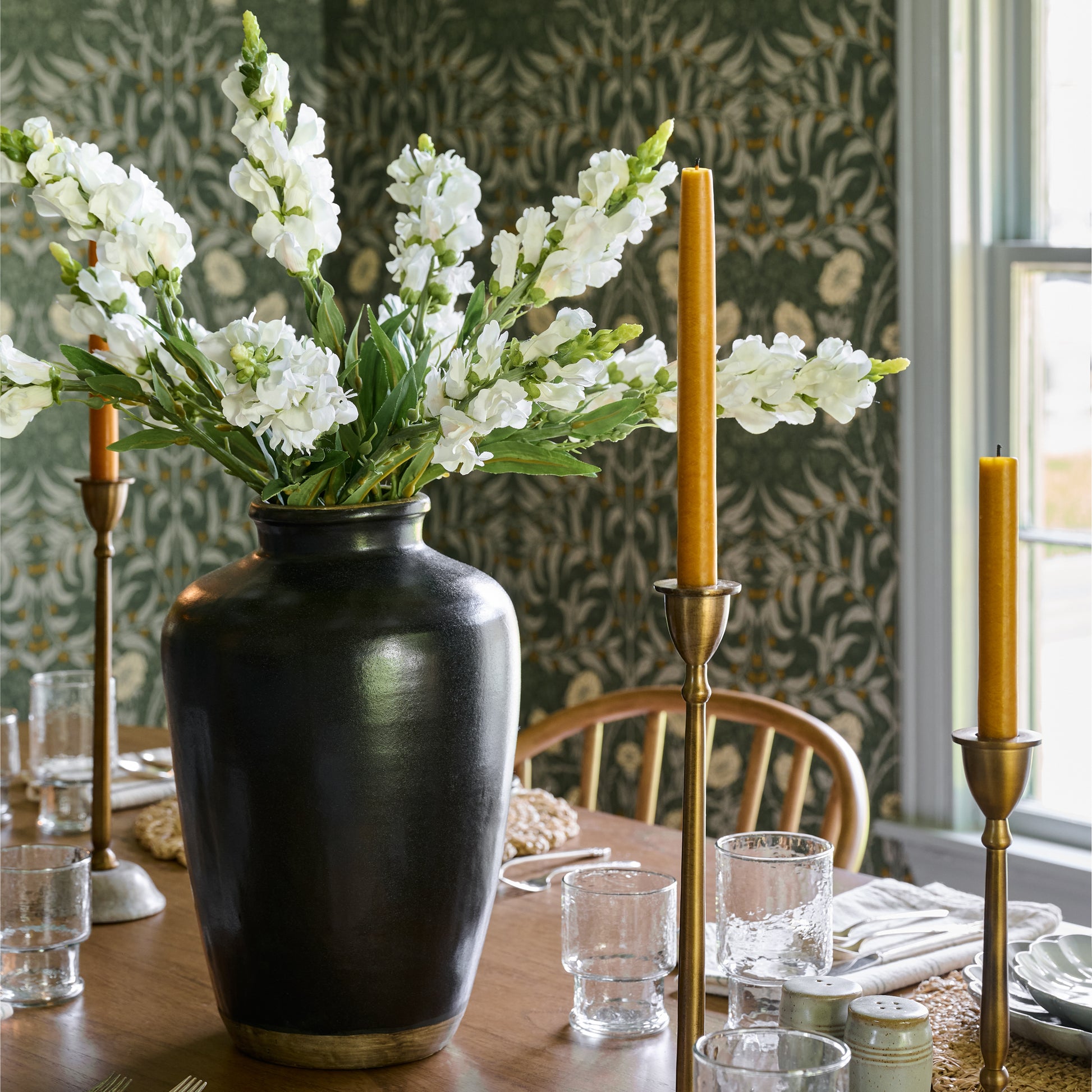10" Hand Dipped Spun Finish Tapers in antique gold in candle holders on a table