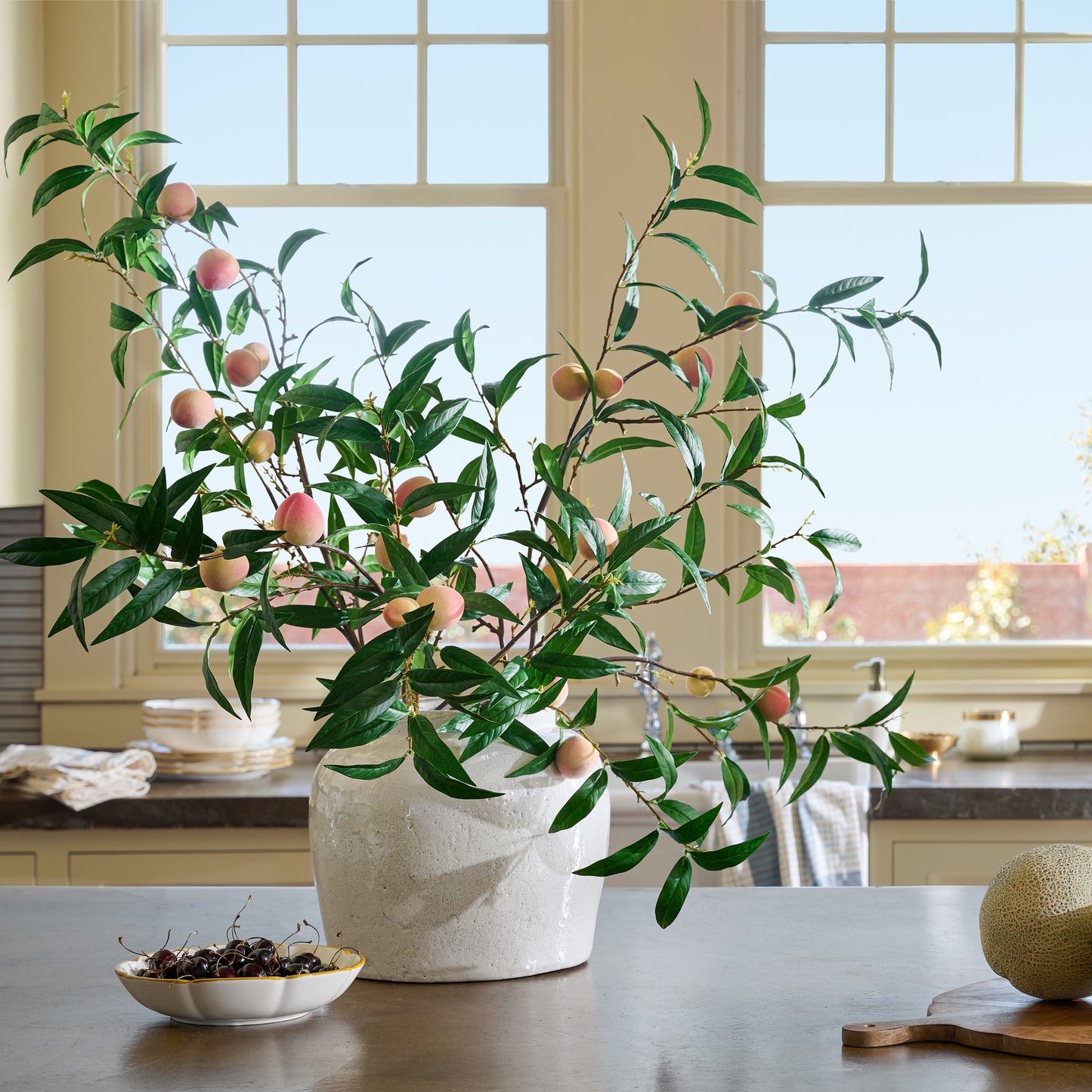 Oversized Peach Stem in a vase on a table
