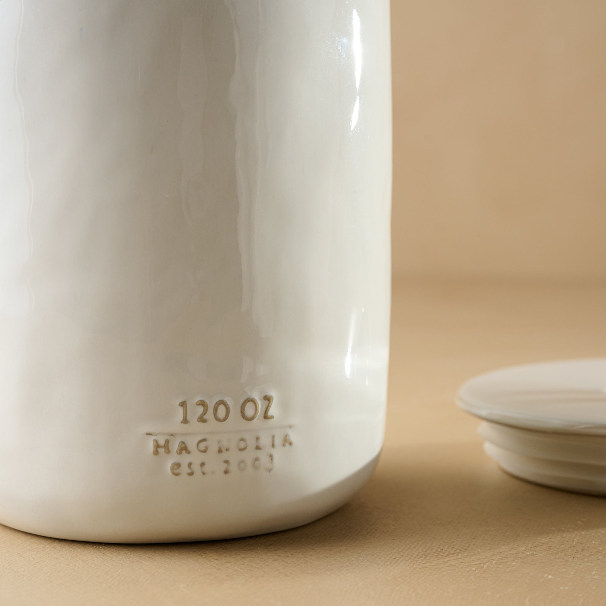 Mia Ceramic Canister close up of logo and Oz label