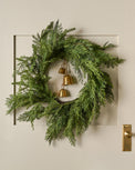 Real Touch Cedar Mix Wreath shown hung on door with bells