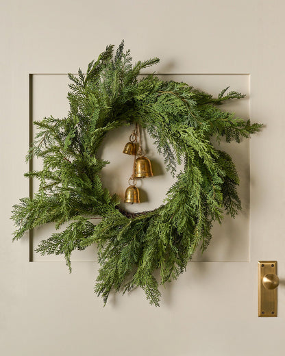 Real Touch Cedar Mix Wreath shown hung on door with bells