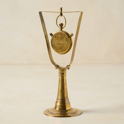 Antique Inspired Hanging Table Clock shows clock turned to the back with magnolia logo on the back of the clock