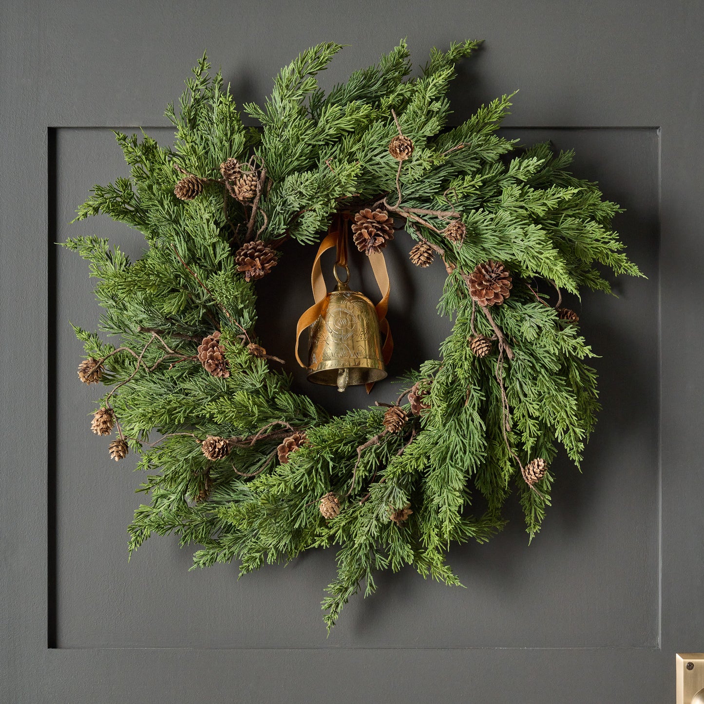 Real Touch Maeve Pine Wreath shown hung on door with bell