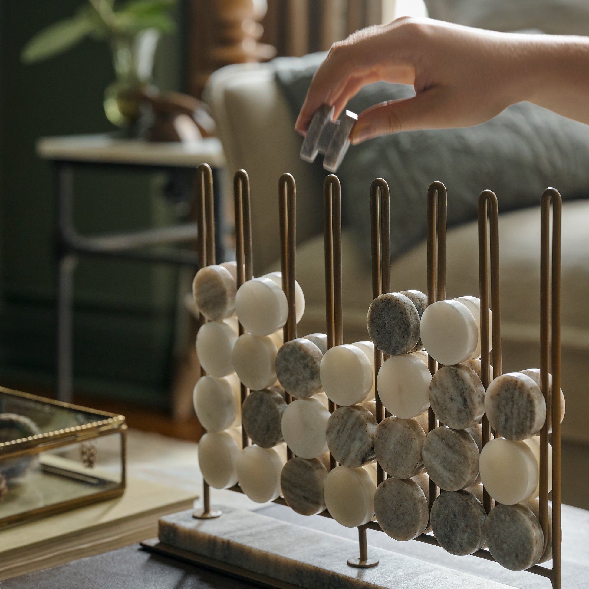 Marble Four In a Row Decorative Game shown being played