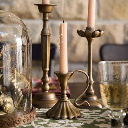 Anna Antique Brass Taper Holder on a dining table
